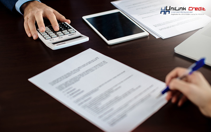 Man signing a debt consolidation loan document.